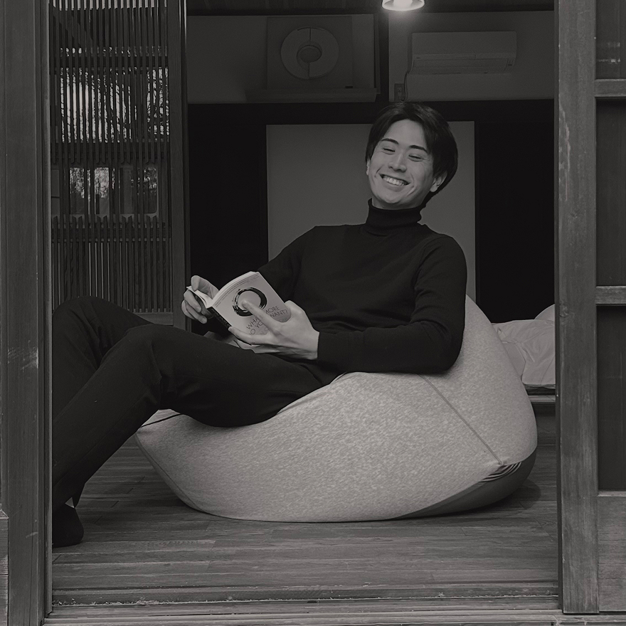 Taiki seated indoors