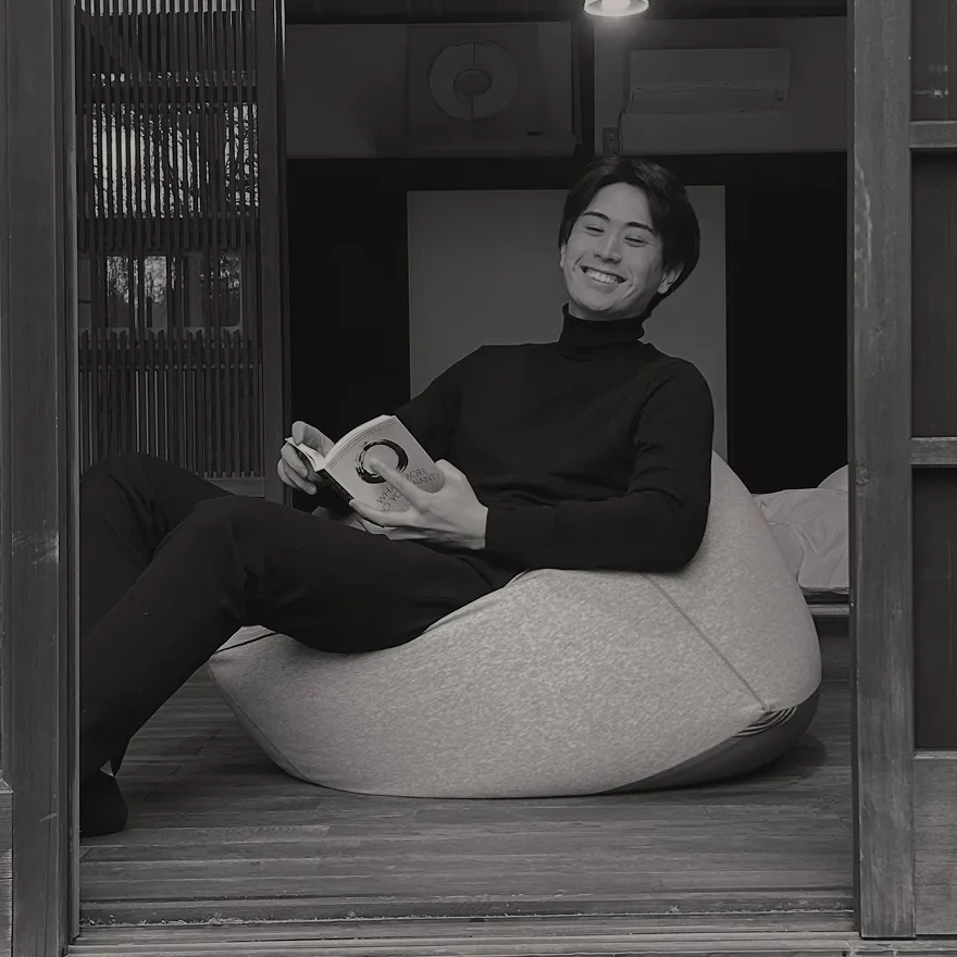 Taiki seated indoors
