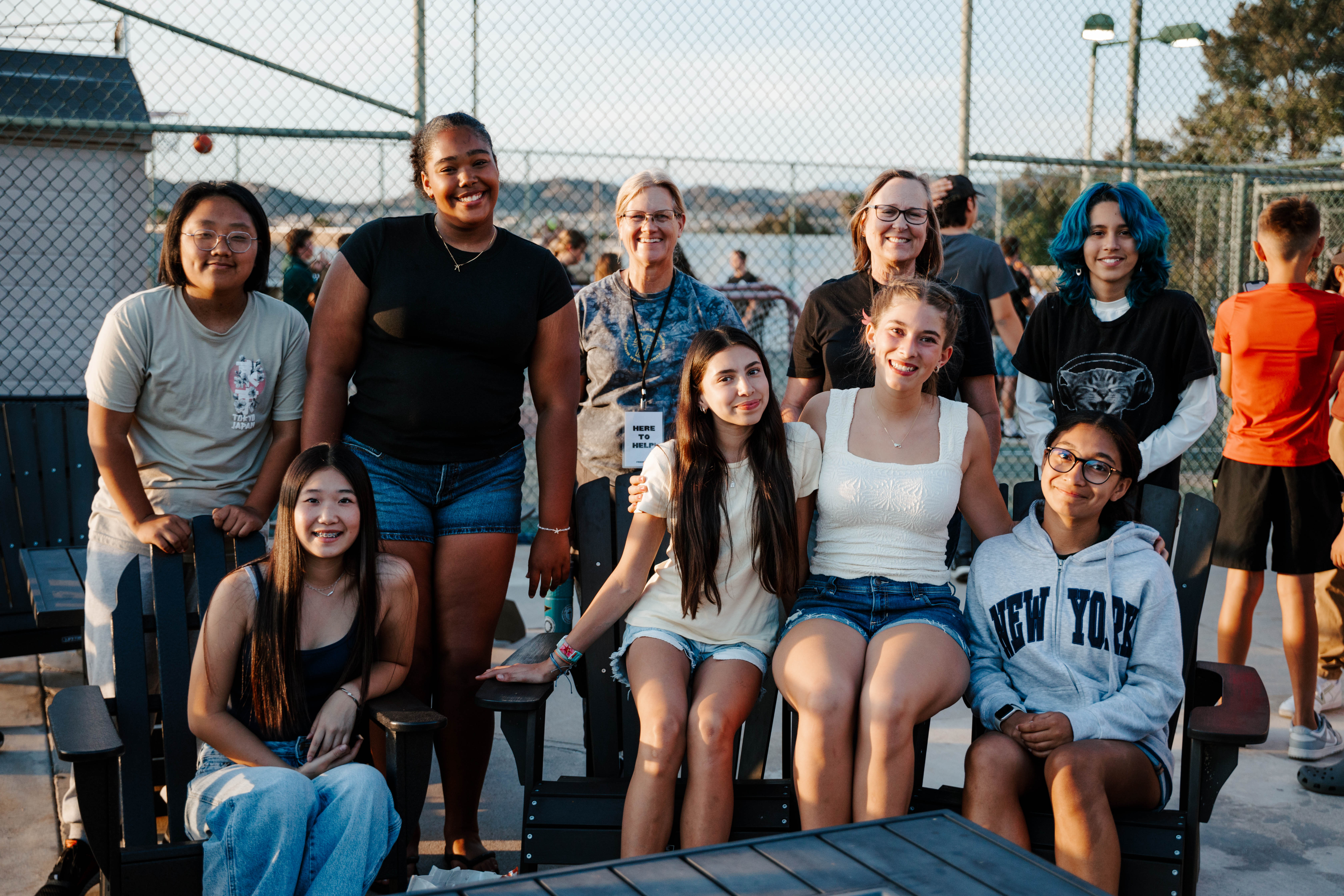 A group of Friends Students smiling together at an outdoor gathering