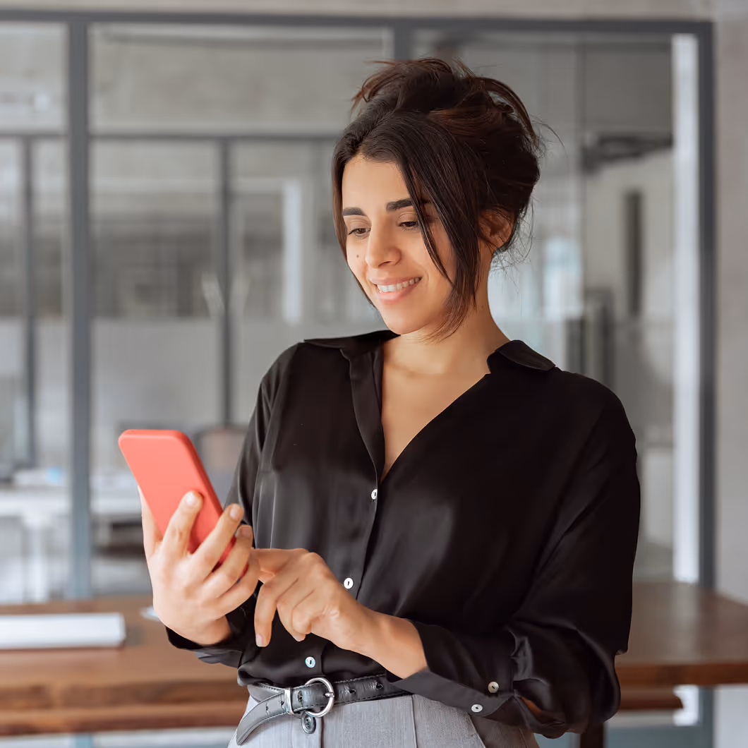 Eine Frau nutzt ganz einfach den Haufe Mitarbeiter-Chatbot auf ihrem Handy.