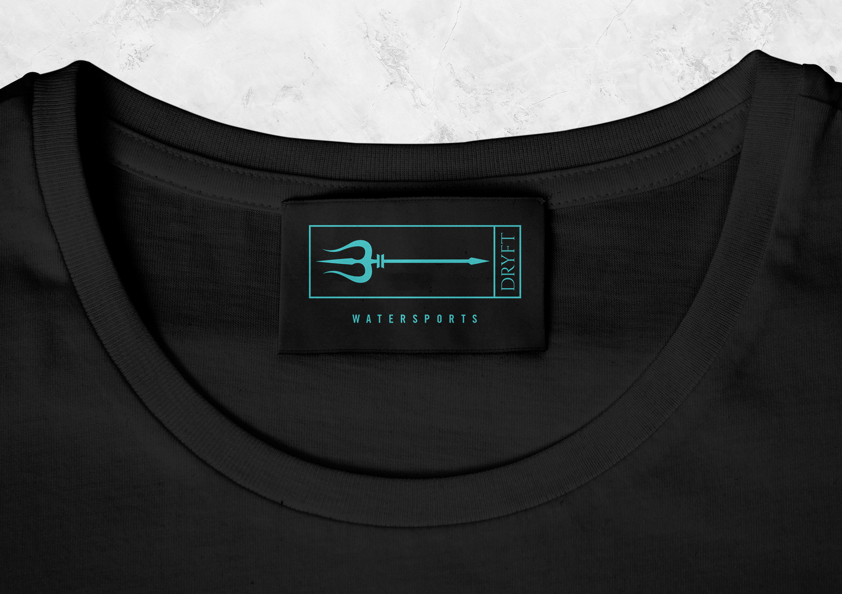 Dryft Watersports alternative logo displayed on a shirt tag. 