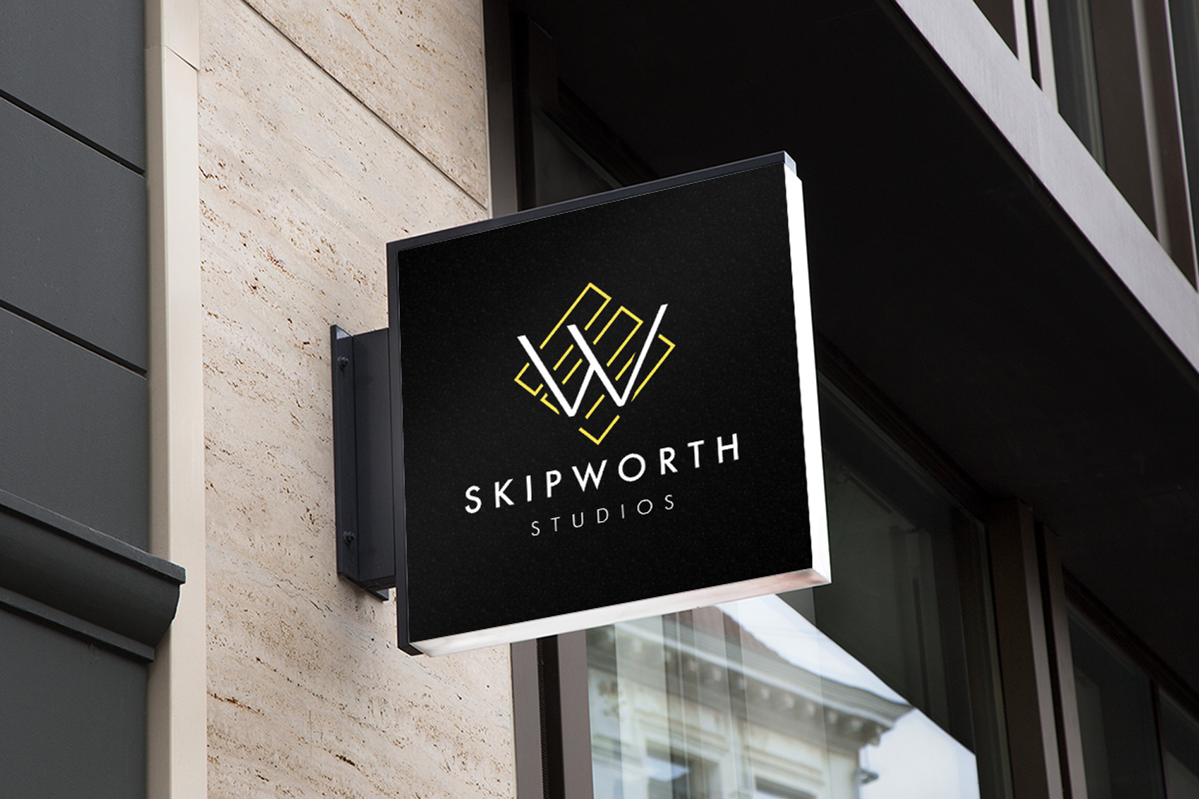 Skipworth studios business sign displayed on the side of a building.