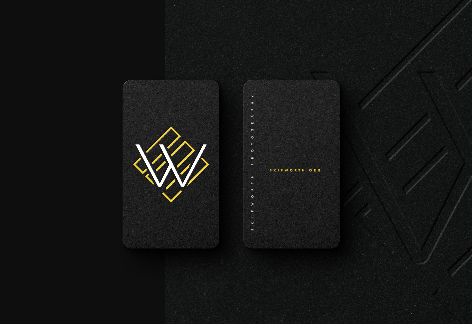 Two vertical business cards with skipworth branding. Skipworth embossed logo mark in the background. 