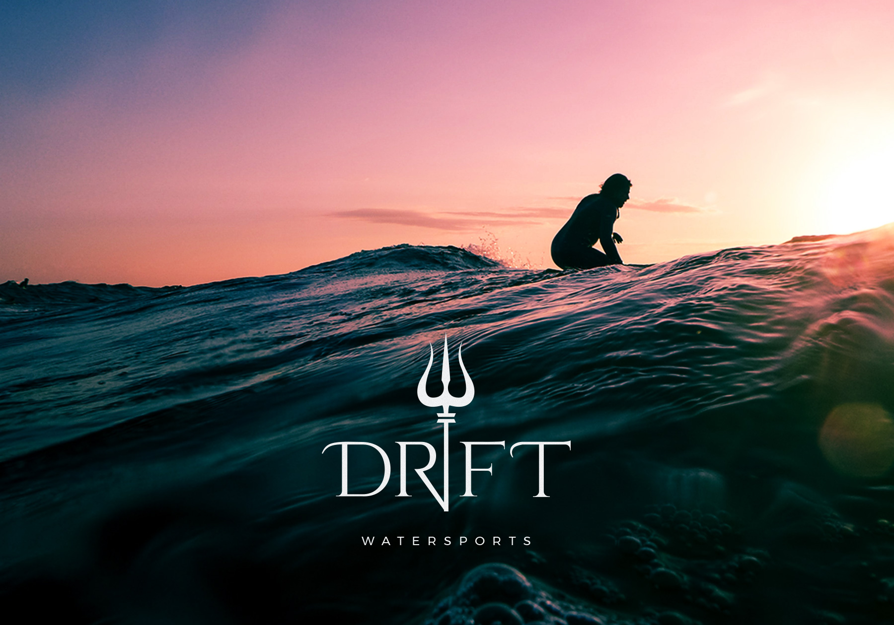 Close up of rocky waves out in the ocean with the "Dryft Watersports" logo displayed in white. 