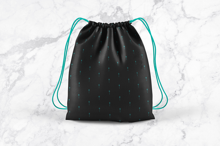 Black drawstring backpack with small teal key patterns and teal cords on a light marble background.