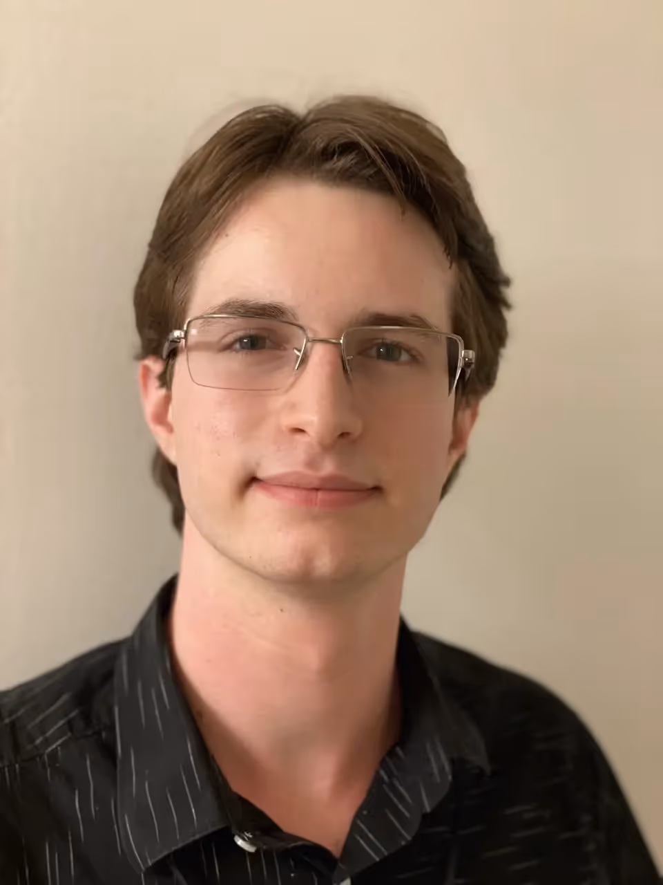 A man wearing glasses and a black shirt. - Assistments - Formative Assessment Solutions