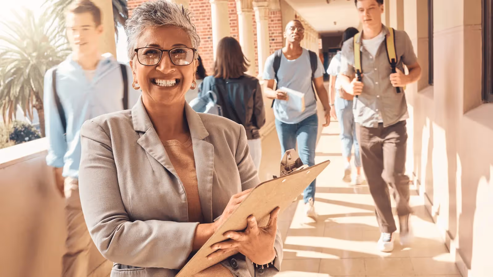 A woman holding a clipboard with a smile on her face.