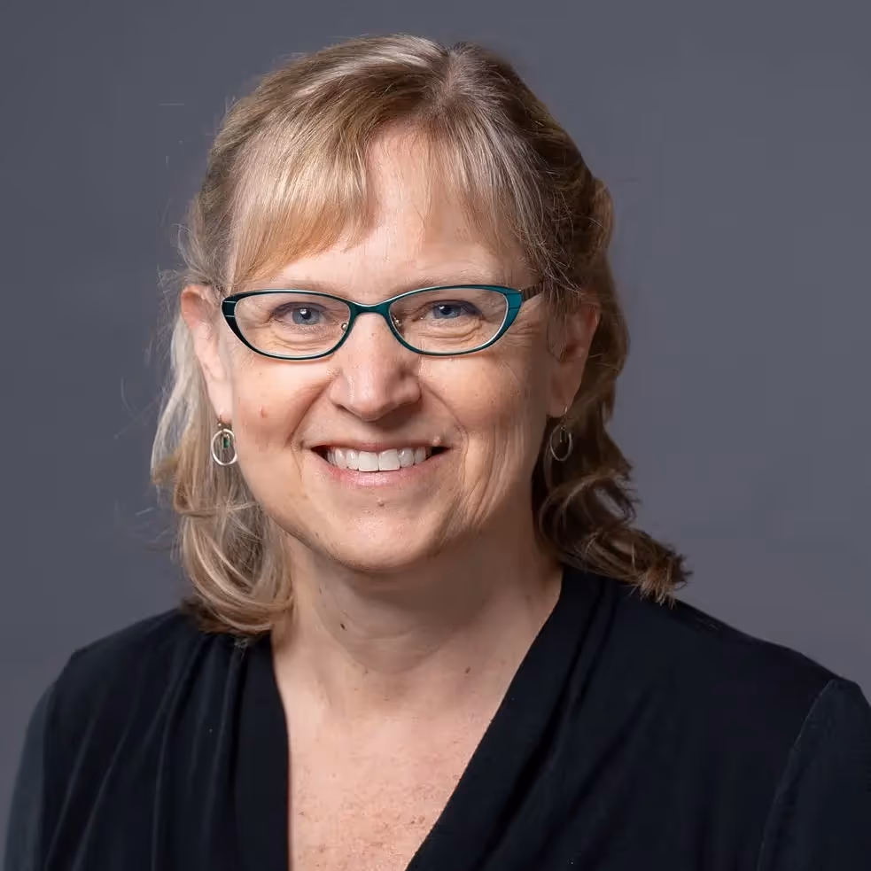 A woman wearing glasses and a black shirt. - Assistments - Formative Assessment Solutions