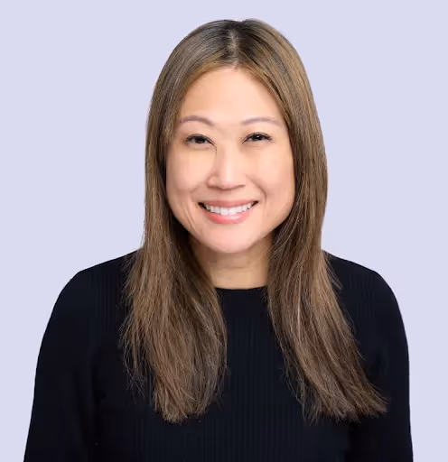 A woman with long hair and a black shirt smiling. - Assistments - Formative Assessment Solutions