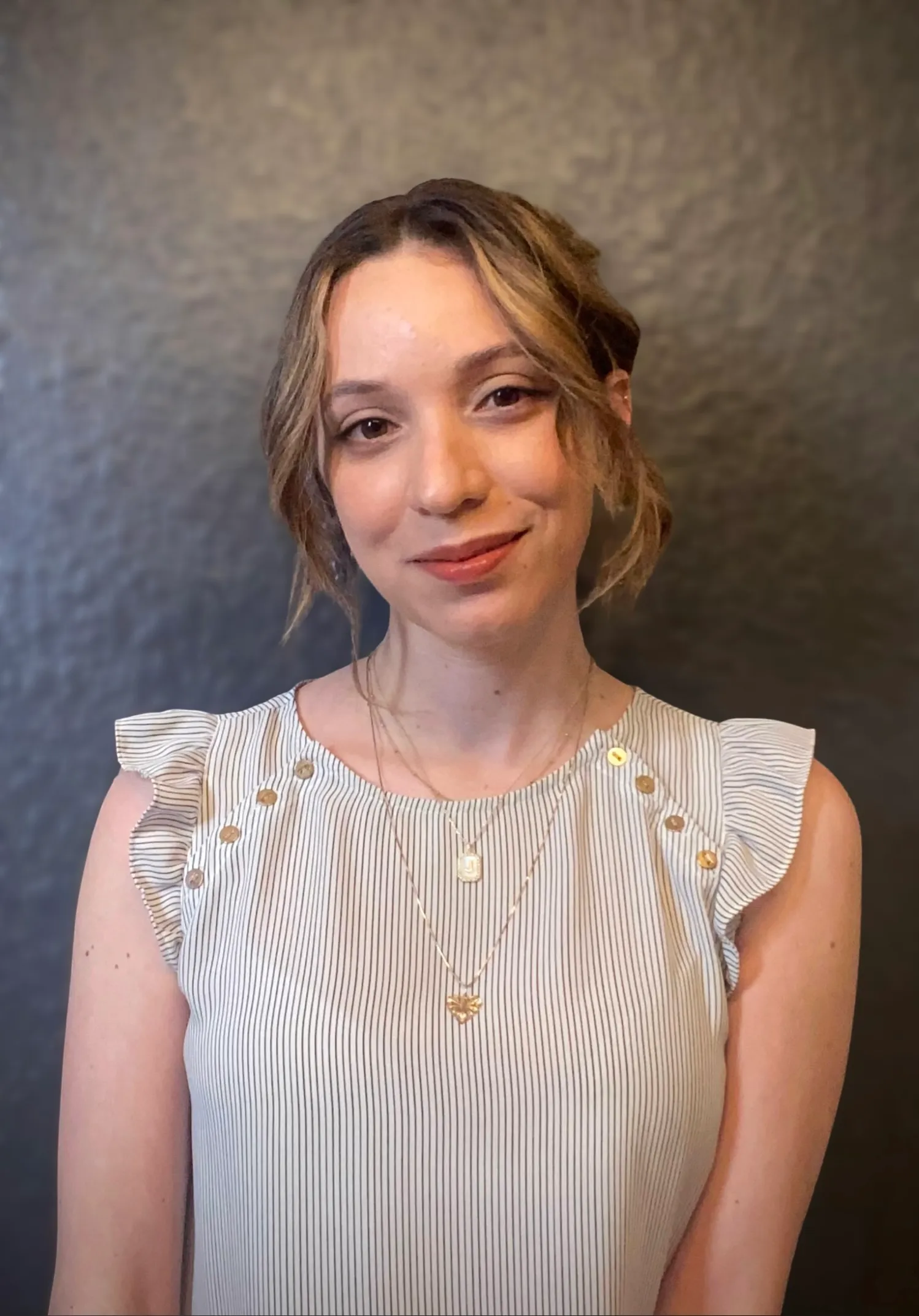 A woman wearing a white shirt with a gold necklace. - Assistments - Formative Assessment Solutions