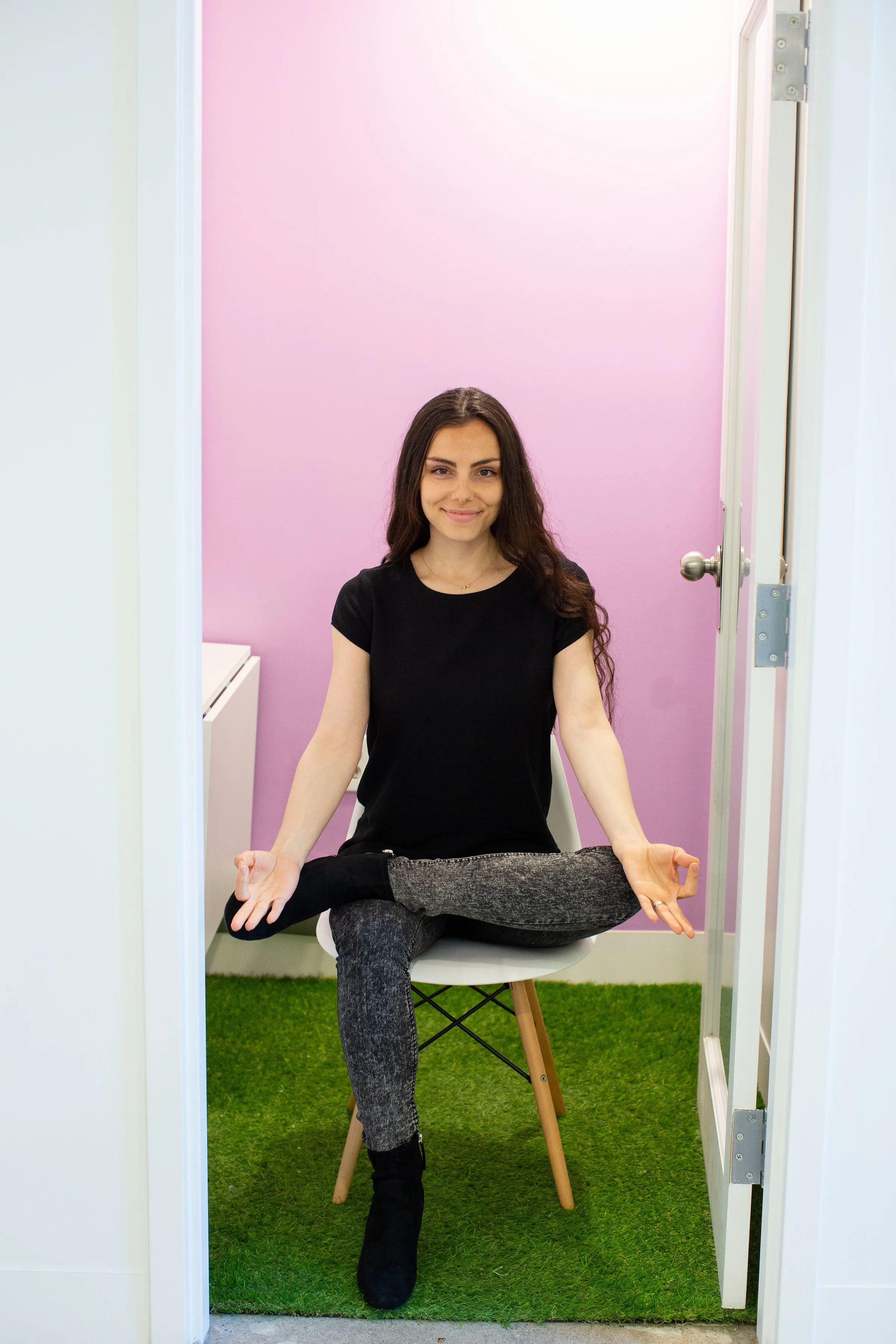 Inna, Utkata Yoga’s founder, demonstrating chair yoga while seated in everyday clothes