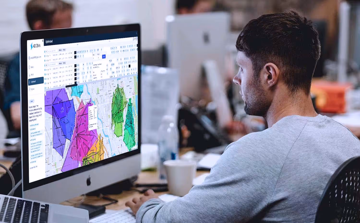 Fleet operator using Adiona FlexOps Fleet Simulator software on desktop computer