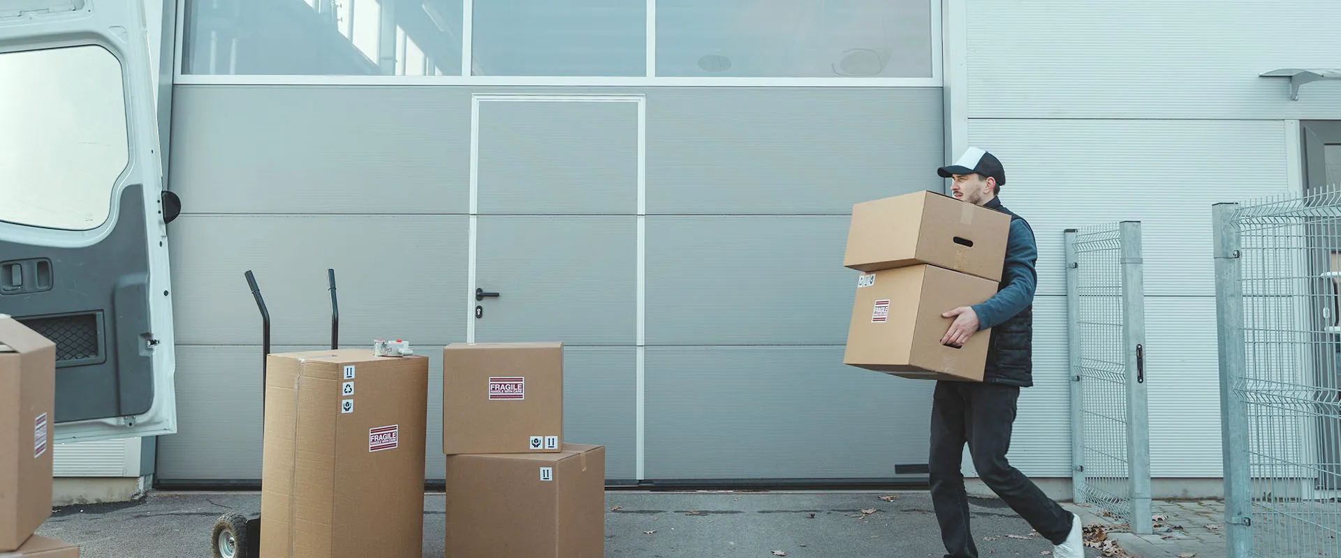 delivery driver packing boxes into back of van