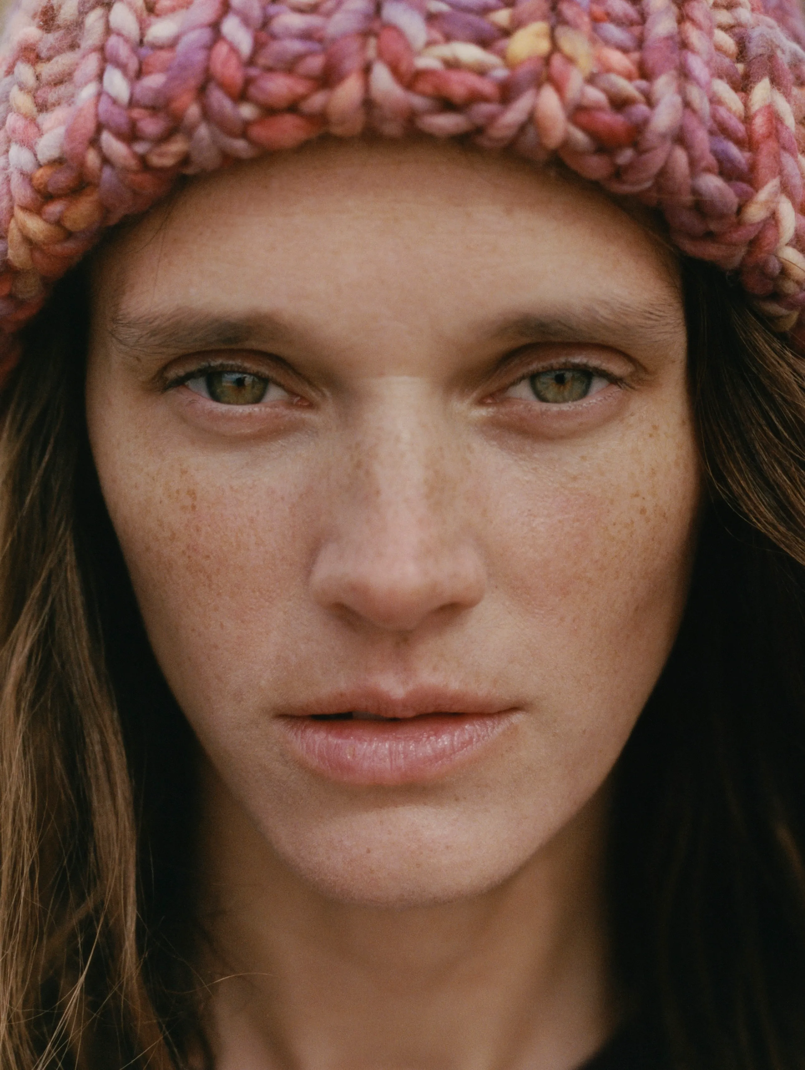 engaged couple laying in grass at the Ottawa Dominion Arboretum photo session