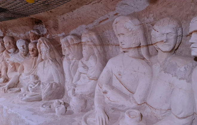 Detailed underground sandstone carving of The Last Supper scene.