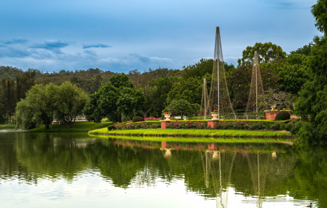 Scenic view of Hunter Valley Gardens with reflections on a calm lake.
