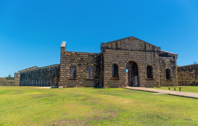 Front view of Trial Bay Gaol's historic stone building under a clear blue sky.