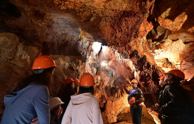 Tour group exploring the underground formations at Wellington Caves, New South Wales.