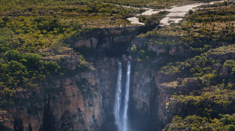 Aerial view of Jim Jim Falls cascading through rugged cliffs and tropical forest in Kakadu National Park.