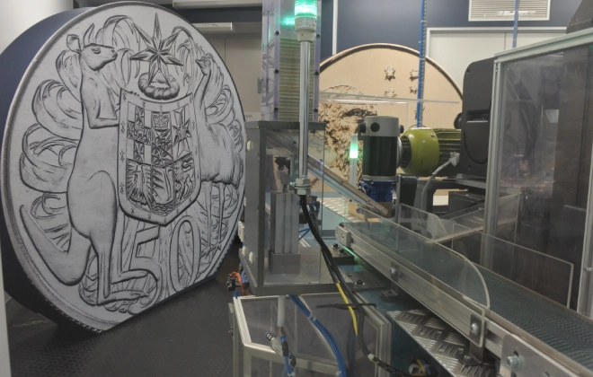 A close-up shot of a minting machine at the Australian Mint