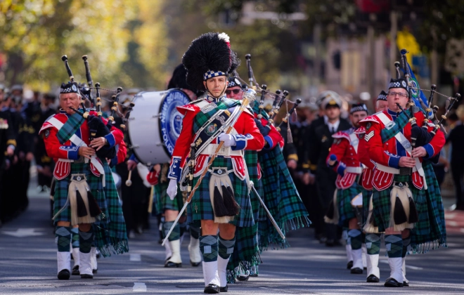 A group of war veterans, military people, widows, and descendants march during the ANZAC Day parade.