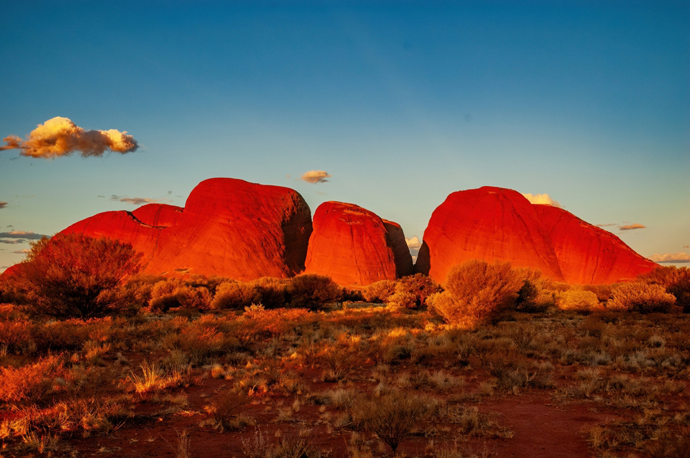 Kata Tjuta’s red rock domes glowing at sunset in the Australian outback.