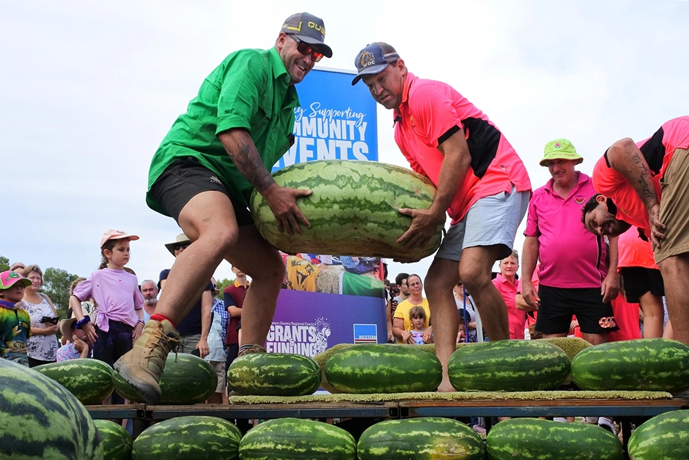 Participants lifting a giant watermelon during the Chinchilla Melon Festival in Queensland.