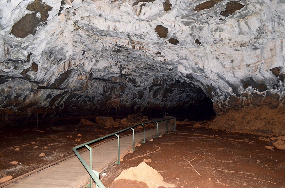 Walkway inside the Undara Lava Tubes in Queensland, showing the vast underground volcanic cave.