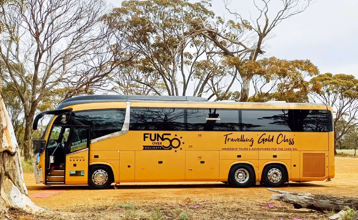 Gold Class Fun Over 50 Holidays coach parked outdoors with the passenger door open