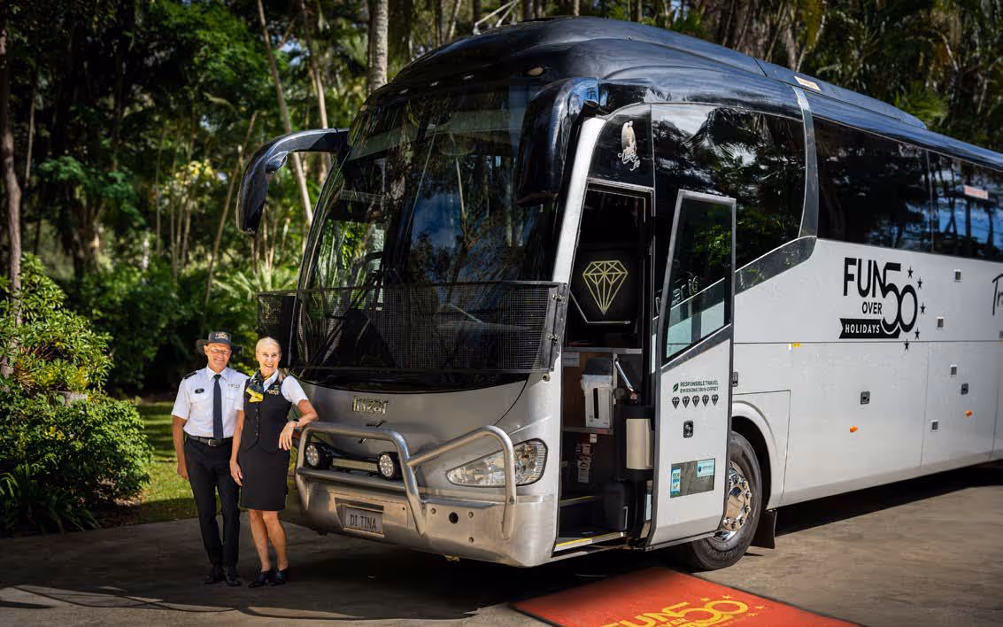 Diamond Class Fun Over 50 Holidays coach with staff standing at the red-carpet entrance