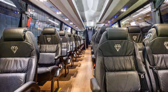 Interior of a Diamond Class coach showing premium black leather seats with diamond-quilted upholstery