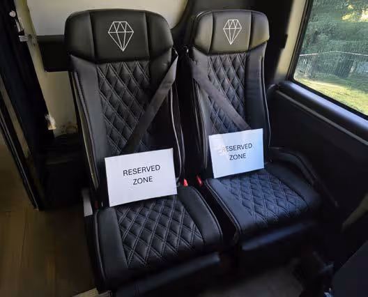Diamond Class coach seats marked with Reserved Zone signs for quiet or sensitive seating