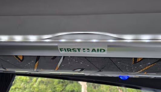 First Aid sign on an overhead panel inside the coach