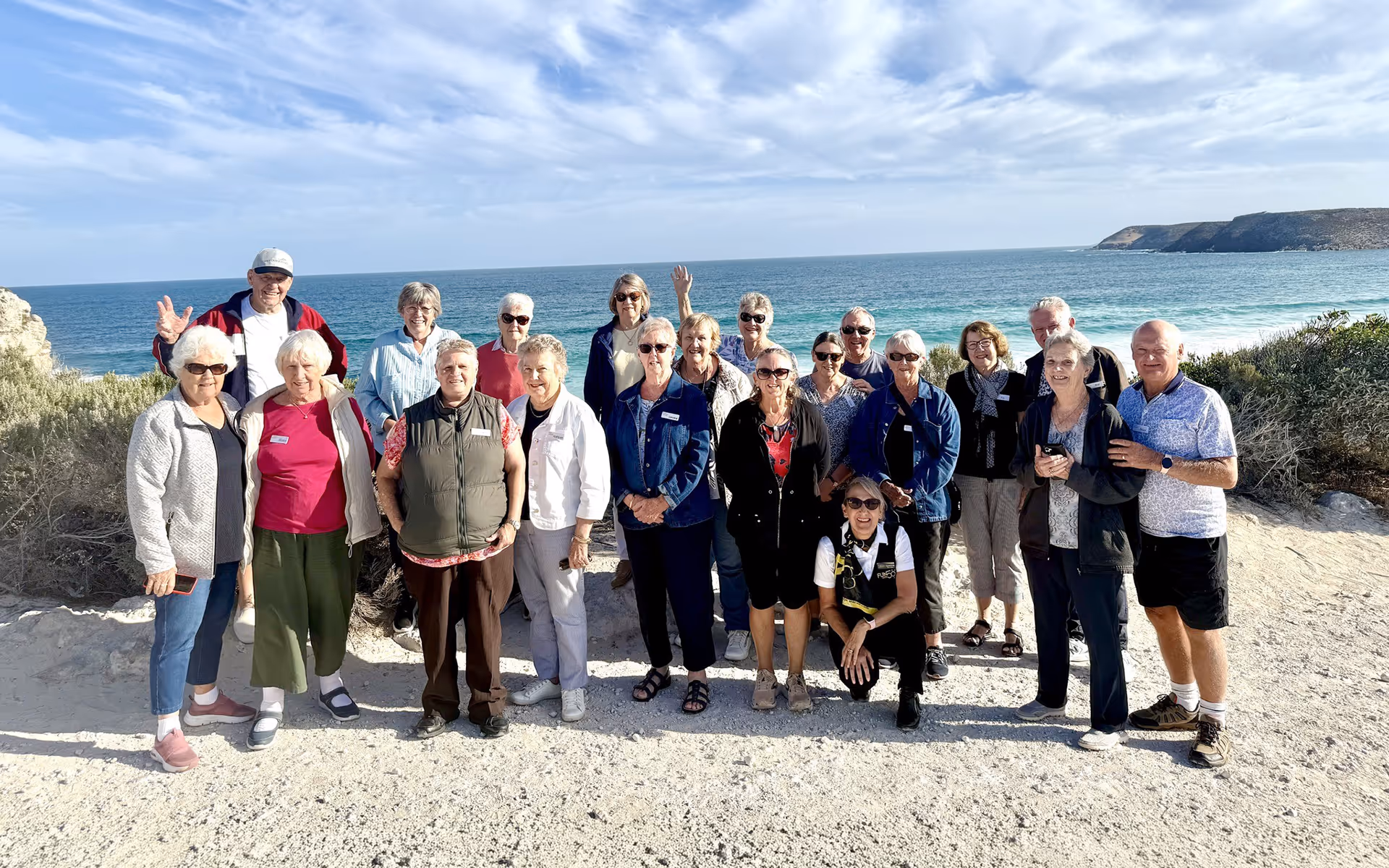 Group of Fun Over 50 Holidays guests posing together on a coastal lookout during a tour