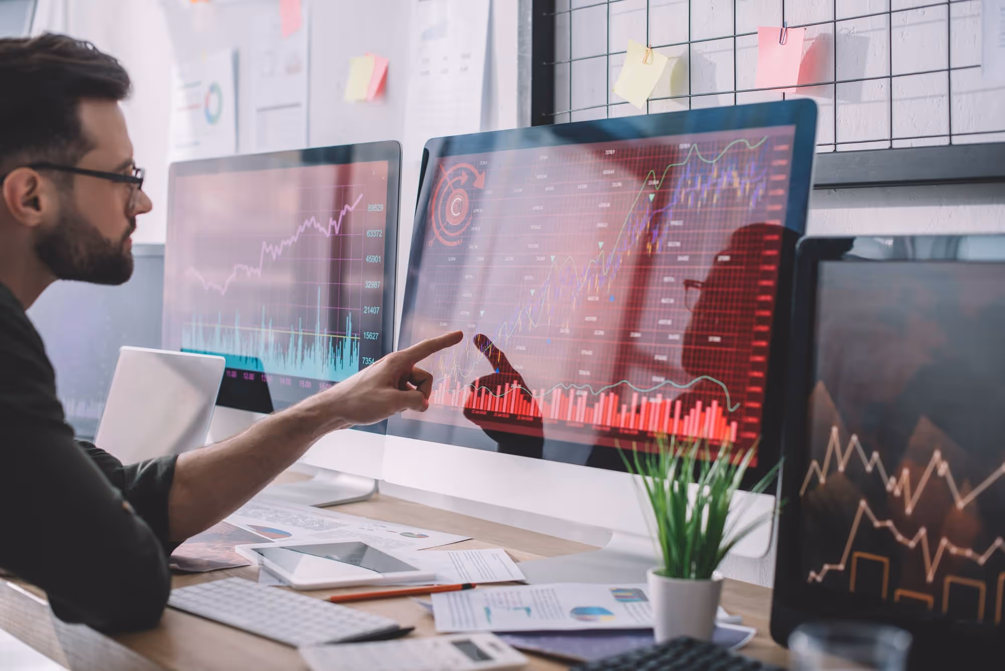 Man looking at a data dashboard on a desktop screen
