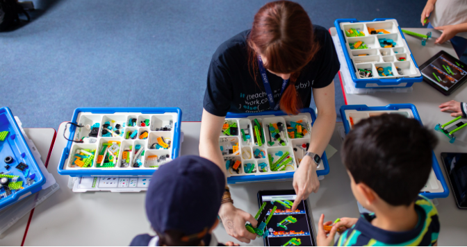 Coding teacher teaching children basic coding