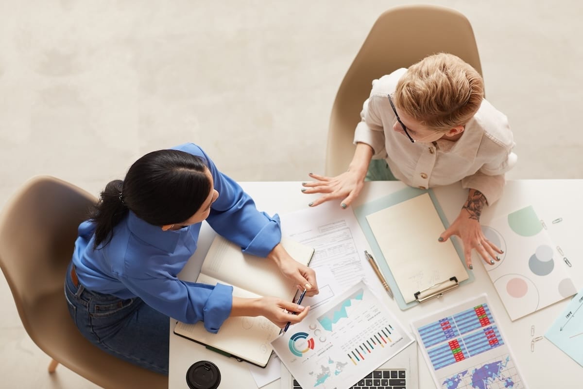 Two women analyzing marketing data