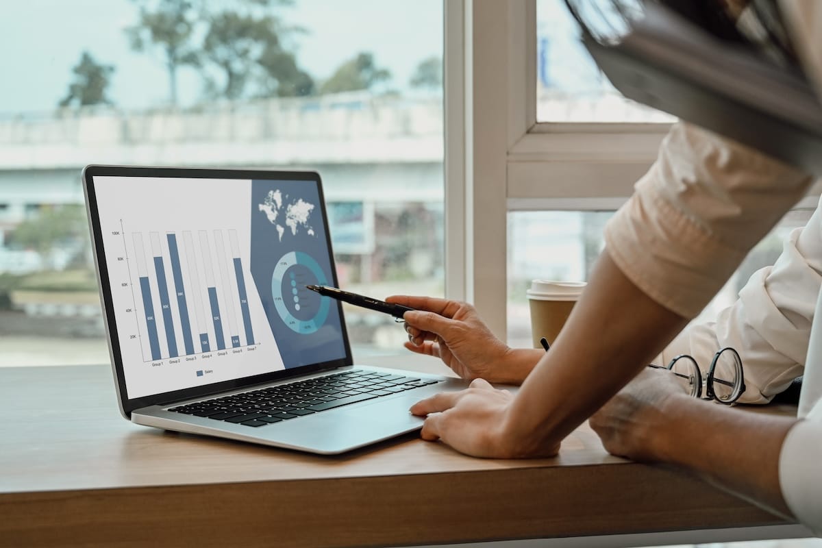 Business team analyzing data on a laptop