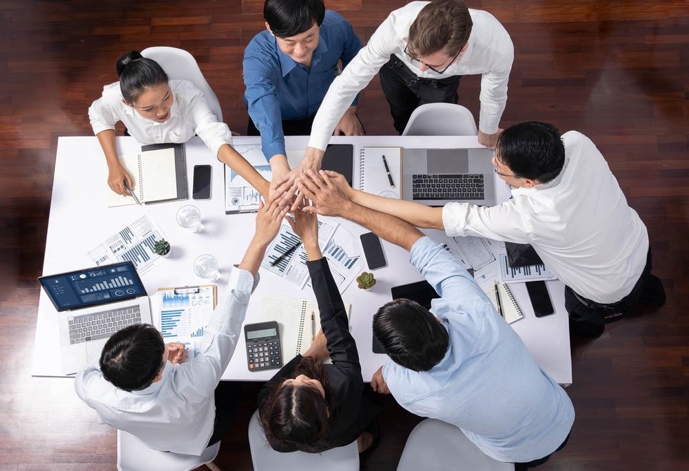 A team putting all their hands in.