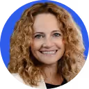 Smiling woman with curly blonde hair against a blue circular background.