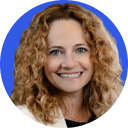 Smiling woman with curly blonde hair against a blue circular background.