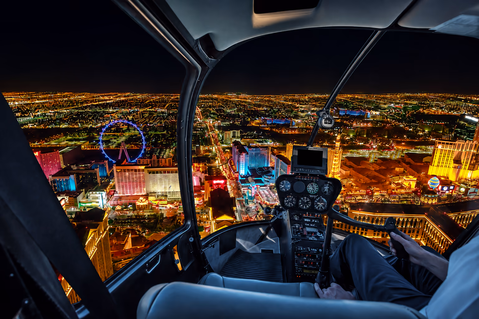 View from a helicopter cockpit over Las Vegas at night