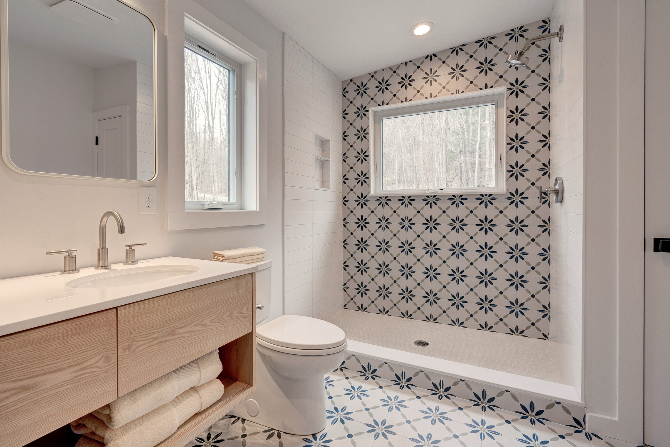Blonde wood, scandi-style tile with stainless fixtures. 