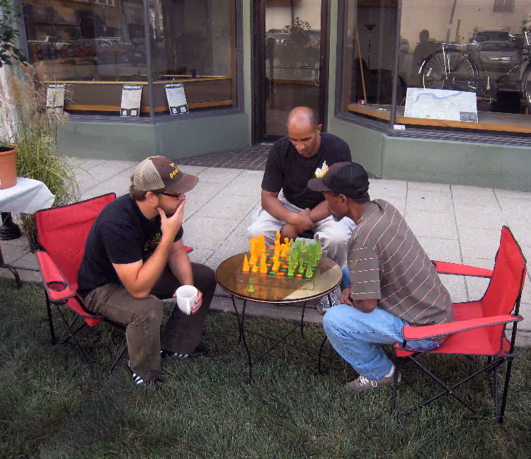 Piuma playing chess at the UDS Park(ing) Day parklet