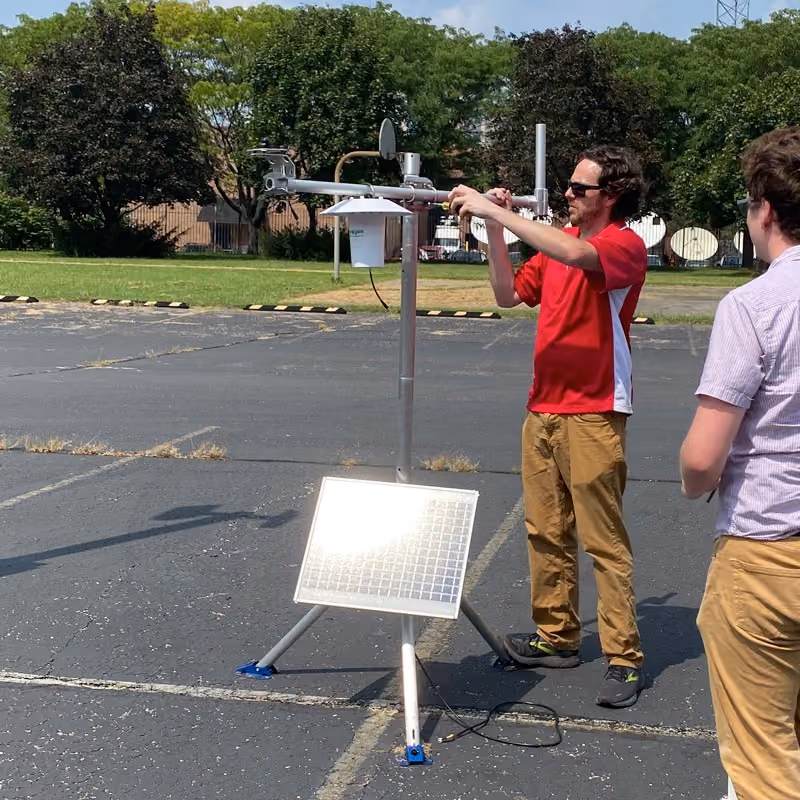 researchers setting up weather station
