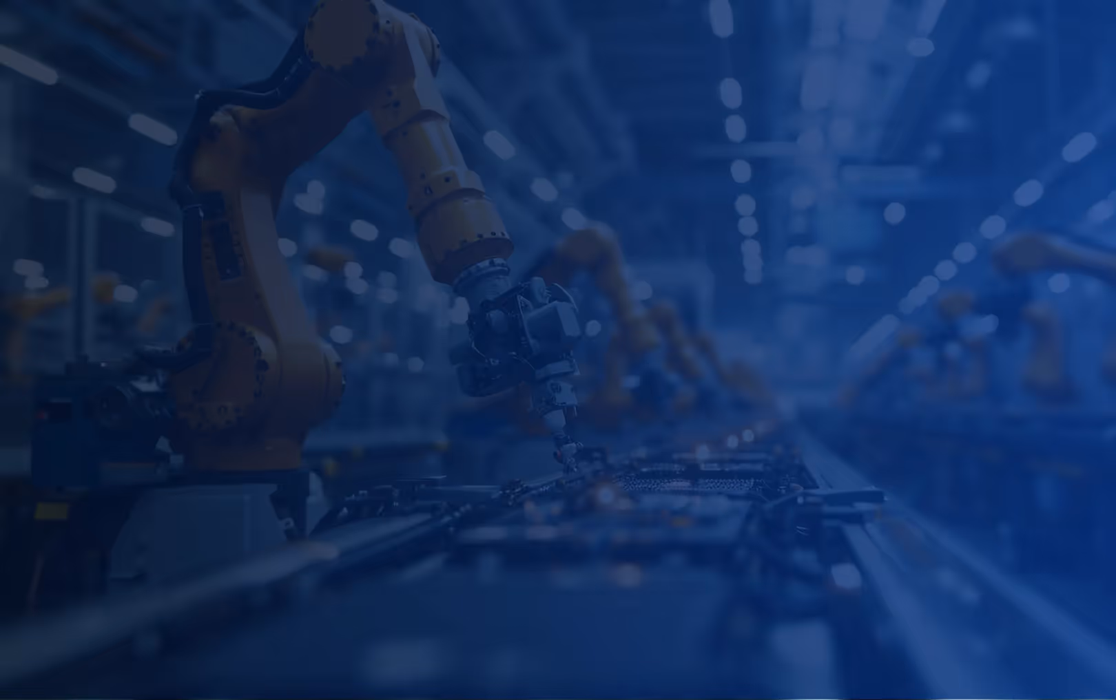 Robotic arms assembling electronic components on a factory production line.