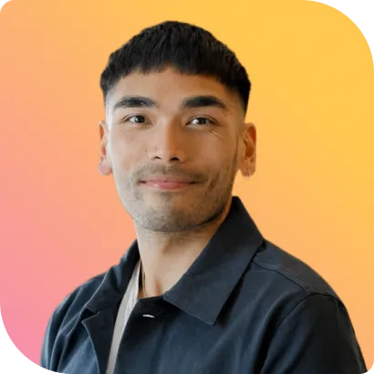 A man in a black shirt is smiling at the camera.