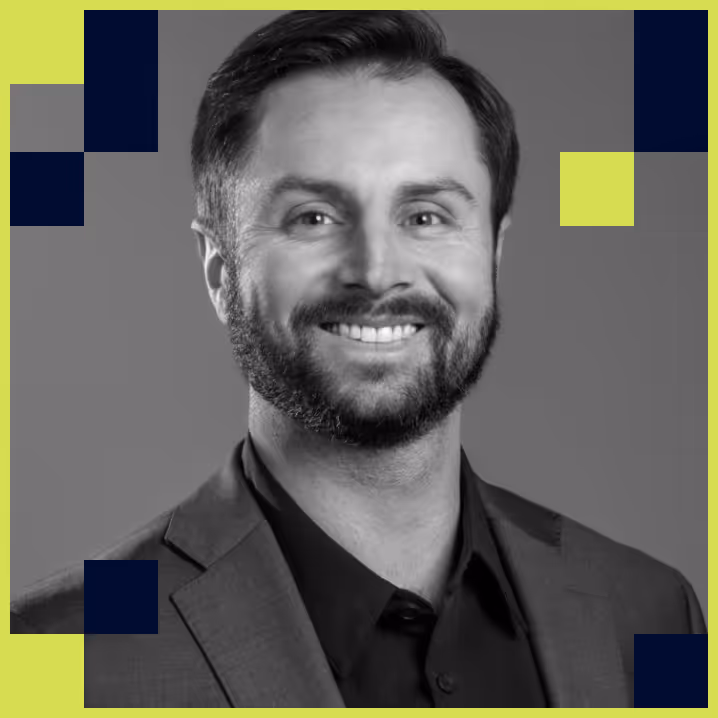 Smiling man with beard wearing a dark suit and shirt, portrait in black and white with geometric accents on a lime green background.