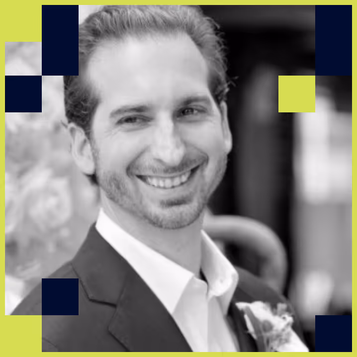 Smiling man in a suit with a boutonniere, black and white photo with a green and blue graphic border.