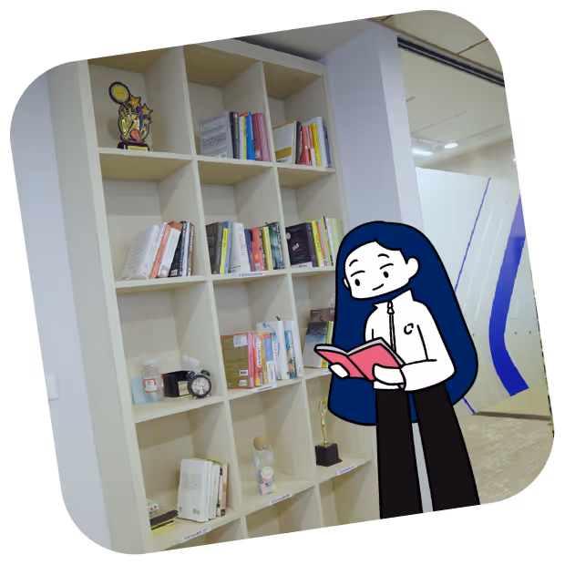 Cartoon character with long blue hair reading a pink book in front of a white cubed bookshelf with books and trophies.